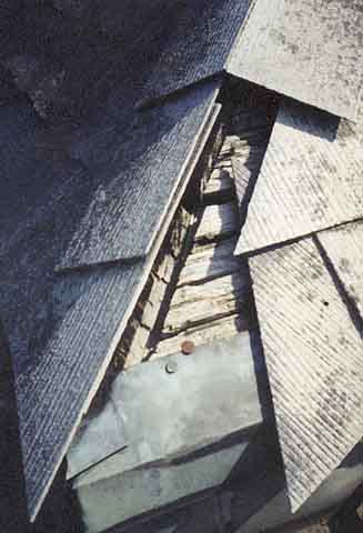 Photograph of missing shingles on bell tower roof.