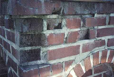 Photograph of missing bricks atop the bell tower.