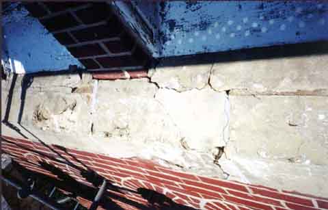 Photograph of severely deteriorated sill cap on belltower.